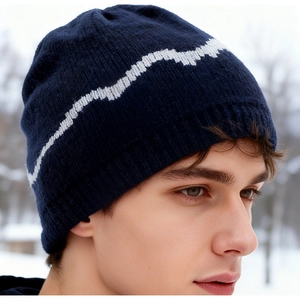 Close-up detail of dark blue knitted winter beanie with white pixelated pattern texture