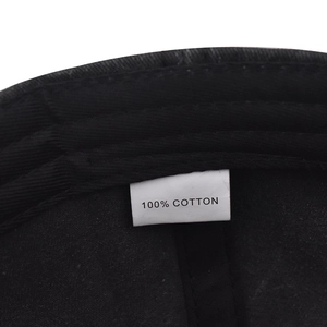 Detail of the internal tag showing 100% cotton material on the black baseball cap