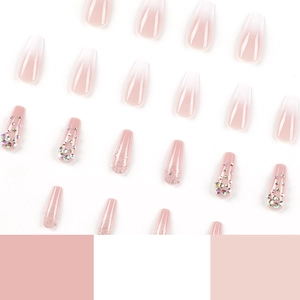Pink and white gradient press-on nails with glitter and rhinestones in coffin shape