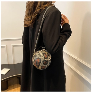 Model showing a leopard print sequin round ball evening bag with gold chain strap