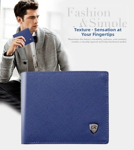 Detail of dark blue Saffiano leather wallet with metal shield logo and textured finish