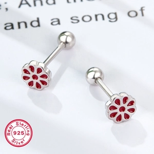 Macro view of 925 sterling silver flower earrings with red glaze and screw ball backs
