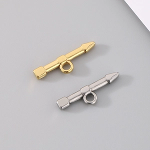 Detailed view of gold and silver bullet-shaped toggle clasps for DIY jewelry making