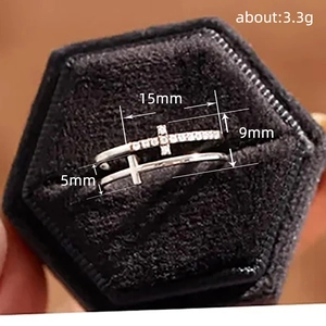 Silver double layer cross ring with embedded diamonds in a black velvet jewelry box