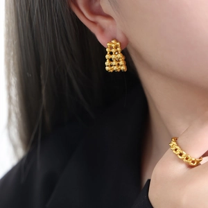 Golden stack-design stud earrings and chain ring set for women in minimalist metal style
