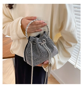 Detail of black mini bucket bag with sparkling silver rhinestones and metal handle