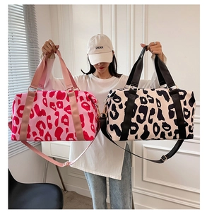 Waterproof cow print oxford travel bag featuring dual handles and adjustable shoulder strap