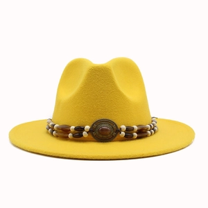Detail of yellow wool felt fedora featuring double-layer beaded band and vintage metal buckle