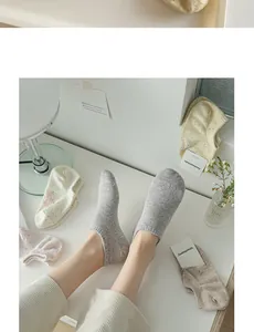 Close-up of low-cut cotton blend invisible socks in speckled grey and pastel colors