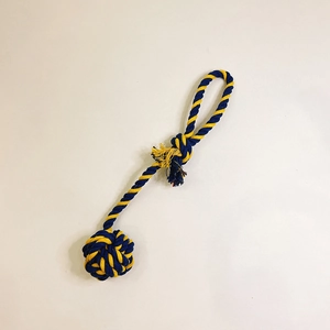 Detail of blue and yellow braided cotton pet rope toy with durable knot and handle loop