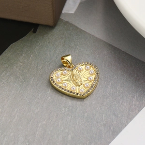 Detail of heart-shaped gold pendant featuring Virgin Mary relief with pearls and zircons