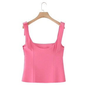 Detail of pink slim-fit camisole with wide straps and square neckline on wooden hanger