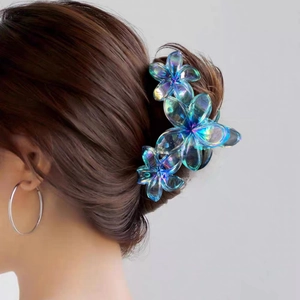 Matte blue flower hair claw clip for women shown on model for elegant hairstyle