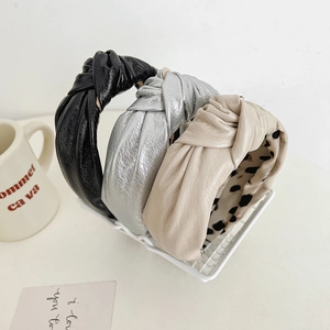 Three-piece set of knotted PU leather headbands in black, silver, and beige with leopard lining