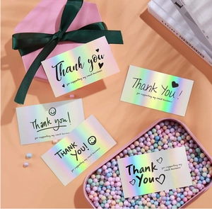 Macro view of holographic rainbow Thank You cards with black small business text on orange base