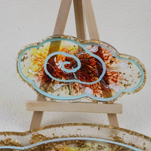 Detailed close-up of cloud-shaped resin tray with gold foil and red marble texture