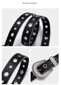 Detail of black punk belt featuring silver metal eyelets and rhinestone horseshoe buckle