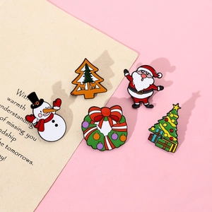 Detailed flat lay of colorful Christmas enamel pins featuring Santa, Snowman and Xmas tree