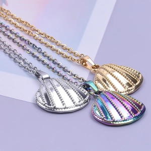 Detailed view of three 18k gold plated shell pendants in gold, silver and rainbow colors