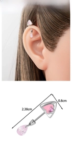Detail of industrial barbell earring with pink heart zircon and teardrop pendant charm