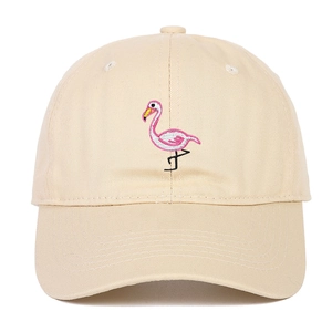 Close-up of pink flamingo embroidery on a beige cotton canvas baseball cap