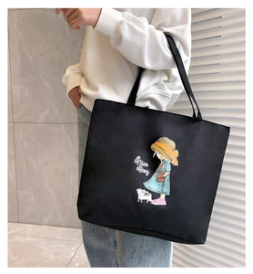 Detail of black canvas tote bag with girl and cat illustration and Nice Day print