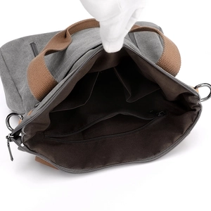 Spacious gray canvas tote bag interior with brown lining and functional pockets