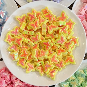 Close-up of dual-color butterfly beads with pre-drilled holes for DIY hair accessories