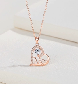 Macro detail of rose gold heart pendant with Mom lettering and sparkling zircon stone