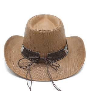 Close-up of woven brown western cowboy hat with embossed band and colorful bead accents
