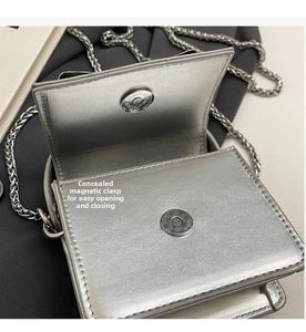Detail view of mini silver bag showing hidden magnetic snap and textured metallic finish