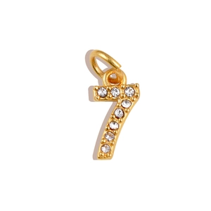 Macro view of gold number 7 pendant with micro-paved white zircon stones and ring