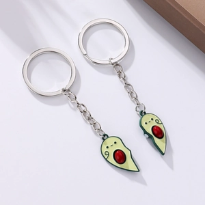 Detail of magnetic avocado couple keychains with polished zinc alloy and drip oil finish