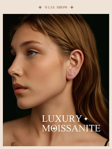 Close-up of infinity shaped S925 silver Moissanite stud earring worn by a model