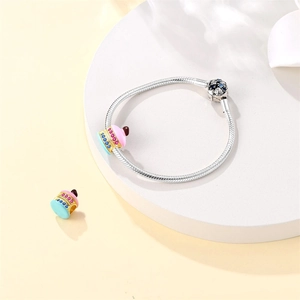 Silver snake chain bracelet featuring a colorful enamel cupcake charm with crystals