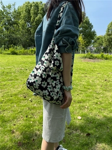 Outdoor shot of floral printed cotton tote bag showing large capacity on model