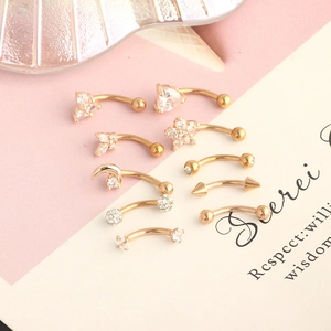 Selection of gold curved barbell jewelry with heart and star zircon charms for piercing
