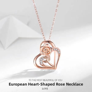 Macro shot of rose gold heart pendant with detailed rose and shimmering zircon accents