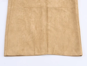 Detailed close-up of the fine stitching and soft faux suede texture on a camel long coat