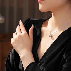 Detail of elegant double-intertwined rings necklace with cubic zirconia on model neck