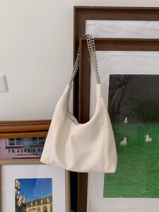 Close-up of soft cream white PU leather tote with stylish silver chain straps
