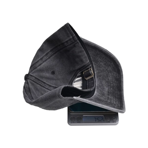 Detail shot showing the 75.2g lightweight washed cotton baseball cap on a digital scale