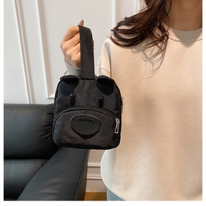 Close-up of cute black bear-shaped nylon handbag with 3D ears and durable wide strap