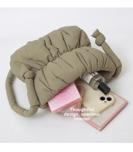 Internal view of khaki puffer bag showing spacious storage for makeup and accessories