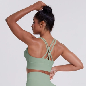 Detail of avocado green sports bra with cross-back straps and high-elastic fabric