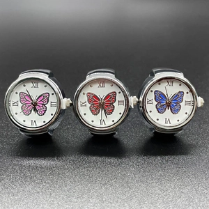 Three minimalist silver quartz ring watches with colorful butterfly dials on black background