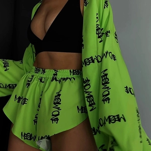 Detail of neon green pajama set with letter prints and elastic waistband shorts