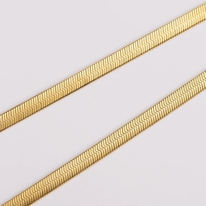 Detail of 5.7mm flat snake chain necklace with 18K gold plating and polished texture