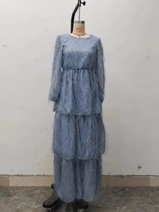 Detail of light blue tiered maxi dress with feathery fringe texture and elastic waist