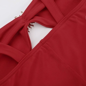 Detail of red hollow-out fish tail dress featuring metallic hooks and knitted texture